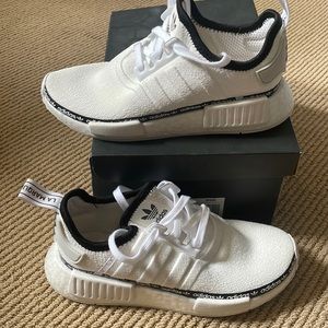 Adidas nmd r2 with logo ribbon.
